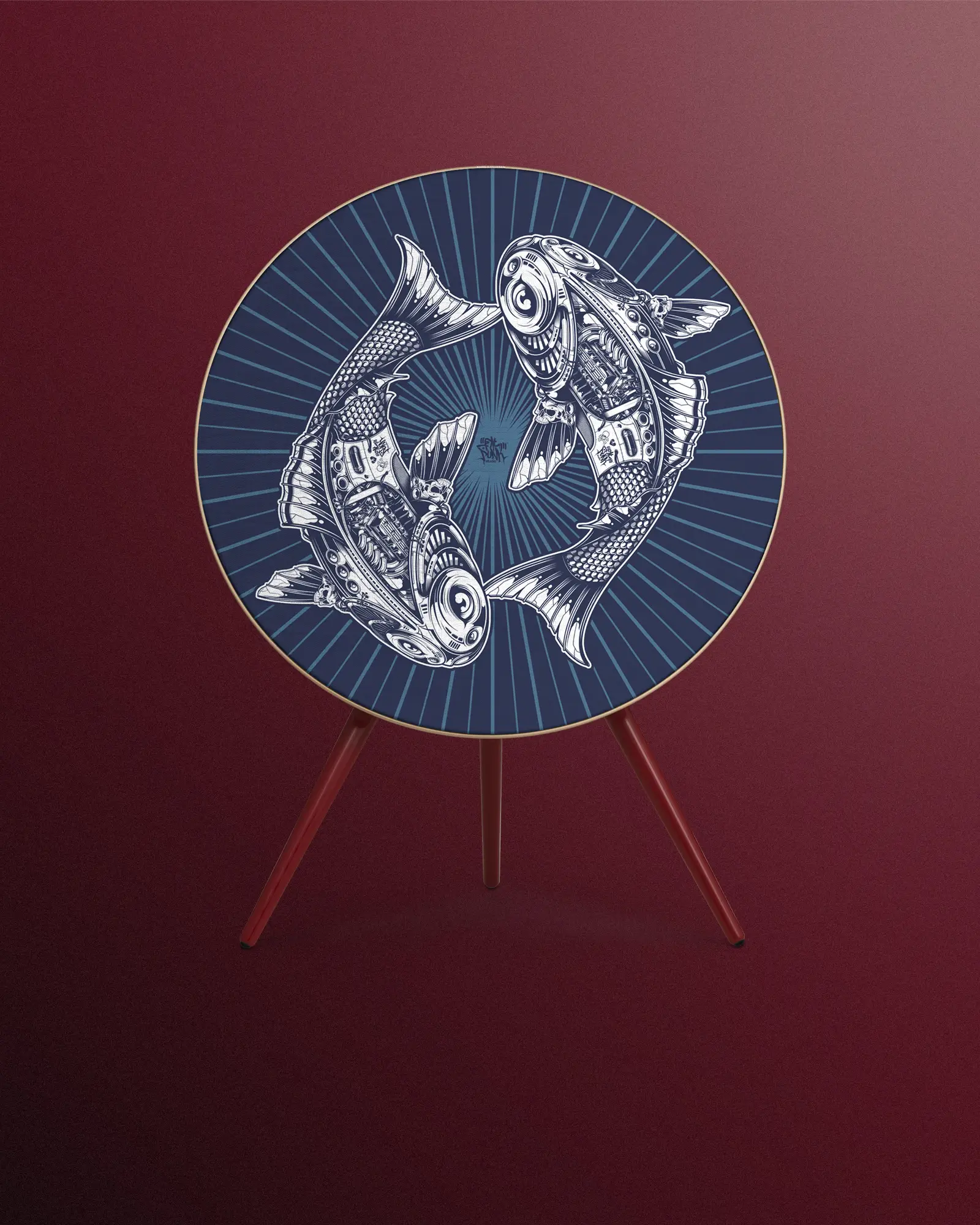 A bang and olufsen speaker with a detailed design of two intricately patterned koi fish facing each other on a blue background. The beosound a9 speaker has a wooden tripod stand and is set against a solid maroon backdrop.